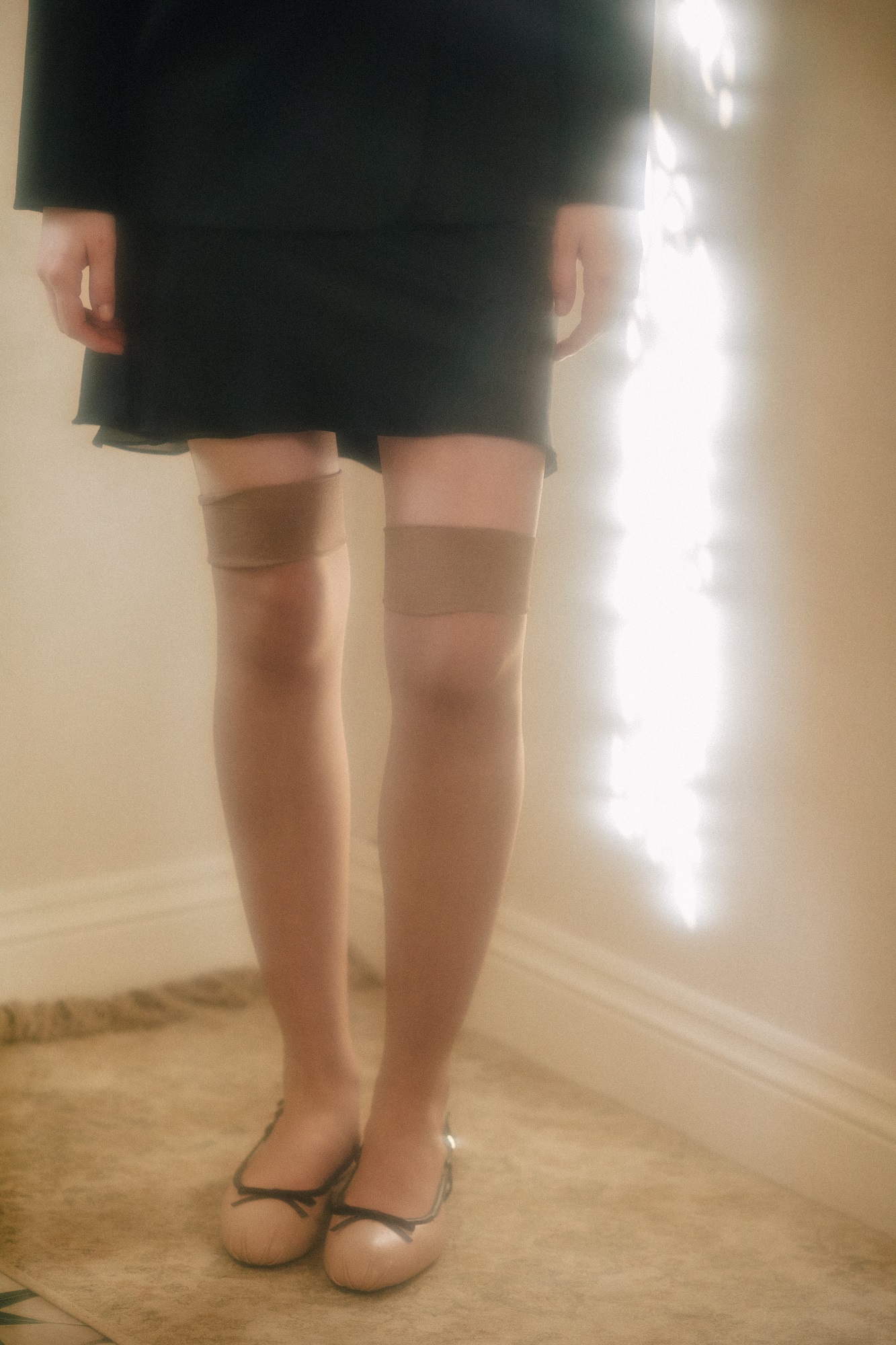 Mini skirt made of black silk with a chiffon insert